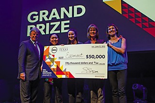 Tommy Meredith (L) with two members of the winning Essmart team, Trisa Thompson, and Suzi Sosa, with the $50,000 Grand Prize for Social Innovation.