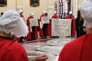 Reproductive rights activists at the Texas State Capitol dressed as <i>The Handmaid’s Tale</i> characters in May of 2017 to protest anti-abortion bills.