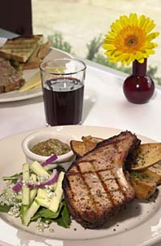 Brown-sugar-smoked pork loin chop with fruited mustard steak fries and apple bleu cheese slaw