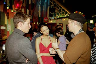 Demme (in beret) directs stars Mark Wahlberg and Thandie Newton in <i>The Truth About Charlie</i>.
