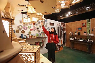 Shopper Naomi Lloyd has her eye on one of these handsome light fixtures at the Blue Genie Art Bazaar, an annual holiday gift-buying opportunity that runs through Christmas Eve at the Marchesa Hall & Theatre at Lincoln Village.