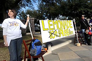 Pease Elementary parents protest the sorry state of school financing by brandishing a sign in front of the Capitol that offers to trade high-priced lemonade for the lemons routinely dished out by state leaders.