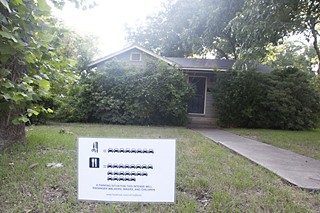 Yard signs like this one appear along Woodview in the Rosedale neighborhood in opposition to a proposal to convert a hair salon into a cafe.