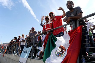 Fans wave a Mexican flag on race day, Nov. 18. Austin-born former driver Tavo Hellmund, who was instrumental in getting Formula One to Austin, was the son of a man who promoted motor sports in Mexico. 