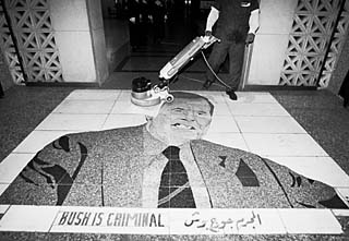 Entrance to Al Rashid Hotel, where diplomats and important media people stay in Baghdad. After the Bush War -- as the Gulf War is known in Iraq -- this mosaic was installed, and guests have to step on George Bush's face as they enter. This photo was taken by Austin photographer Alan Pogue on a trip to Iraq in December.