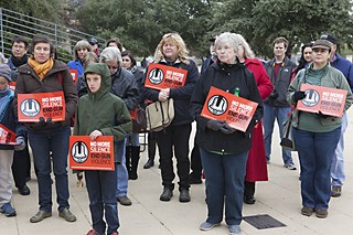 Orane Meacham (l) and 10-year-old Matteo Meacham join a vigil Dec. 14 to mark the one-year anniversary of the school shootings in Newtown, Conn. Texas Gun Sense and Moms Demand Action co-sponsored the event at City Hall.
