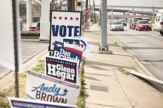 Campaign signs line South Lamar Boulevard in front of Wheatsville Food Co-op on Tuesday, signaling the first day of early voting, which continues through Feb. 28.