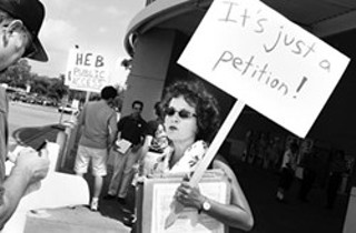 Linda Curtis protests outside of H-E-B in 2002.