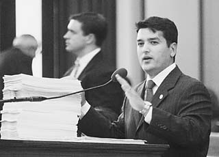 State Rep. Mike Villarreal, D-San Antonio, makes the case against the redistricting bill before the Texas House of Representatives on Monday. The taller stack of papers before Villareal contains witness statements presented to the House Redistricting Committee against redistricting; the shorter stack contains statements supporting the bill. In keeping with the theme of the session, House Republicans ignored public sentiment and pushed the bill through to the Senate.