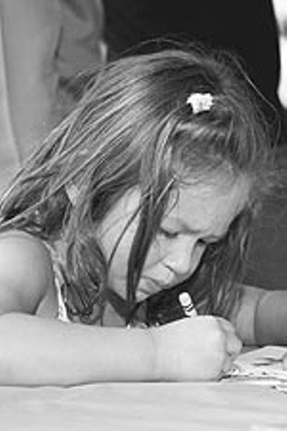 An unidentified young artist applies her crayons with deft sensitivity during the coloring contest at Youth InterACTIVE's Weird Zone at the Keep Austin Weird 5K Fun Run.