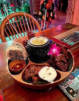 The Pu Pu Platter includes a selection of BBQ beef skewers, mochiko wings, Yokozuna Ribs, Crab Lagoon, taro tots, and house pickles