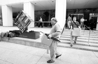 Enron employees pack their belongings and leave the office after the company's 2001 collapse.