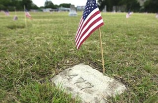 A few days before Memorial Day, volunteers from the Austin State Hospital planted hundreds of American flags at the many unmarked graves at the hospital cemetery located between 51st Street and North Loop, northeast of UT's Intramural Fields. Many of the people buried in the graveyard are of unknown identity, mental-health patients who died in the state's care and often either without relatives or with family who refused to acknowledge their existence in an age when mental illness was extremely stigmatized.