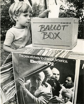 Scott, age 4, casts his vote in a ballot box set up in the family's back yard by his mother.