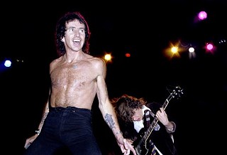 Bad Boy Boogie: (l-r) Bon Scott and Angus Young at San Antonio’s Municipal Auditorium the night after AC/DC’s Armadillo show. Alamo City photographer Al Rendon went to both shows but only shot in his hometown. <a href=http://www.alrendon.com/>www.alrendon.com</a>