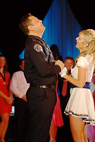 The second-place winner of the Center for Child Protection’s Dancing With the Stars of Austin, Police Chief Art Acevedo (I call him “Ace” – when he lets me) looks heavenward as he greets first-place winner Ronda Gray, founder of Camp on the Move (<a href=http://www.camponthemove.com target=blank<b>www.camponthemove.com</b></a>).