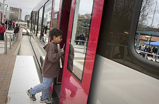 A young boy steps aboard the new MetroRail at an open house Feb. 14 at the Plaza Saltillo Station at Fifth and Comal in East Austin. Capital Metro is holding a series of open houses to familiarize riders with the train.  See <a href=http://www.capmetro.org/><b>www.capmetro.org</b></a> for a complete schedule.