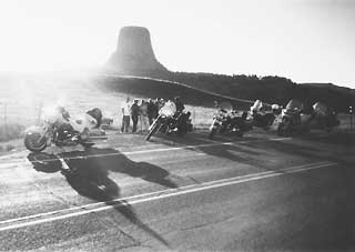 Bikers graciously stop for a picture in front of Devil's Tower.