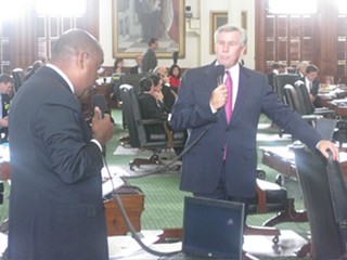 Senators Rodney Ellis (l) and bill sponsor Troy Fraser spar at the Capitol.