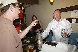 Guest bartender Mike Martinez grabs a cold one for <i>Chron</i> scribe Lee Nichols.
