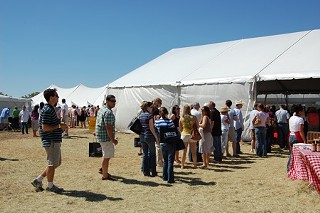 Long line to go into packed to bursting tents