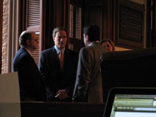 As a storm gathers outside of the House Chamber, Speaker Straus (center) tries to calm one inside