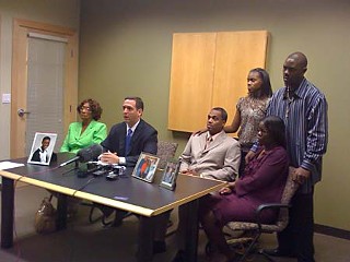 Attorney Adam Loewy (at microphone) is flanked (l-r) by Betty Sanders, grandmother of Nathaniel Sanders II, and parents Nathaniel Sanders Sr. and Yulonda Sanders. Standing are Nathaniel’s siblings, Destiney Sanders and Jecovi Taylor.