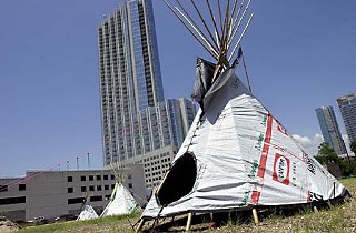 An assembly of tepees in Republic Square Park makes for an interesting study against a backdrop of condos. The two-day installation, which ended Tuesday, was part of a touring Polymorphic Plastic Parade, featuring tepees made of salvaged and renewable resources. Next stop: Marfa.