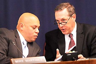 Board Chair Mike Martinez confers with interim Cap Metro CEO and President Doug Allen at Monday's meeting.